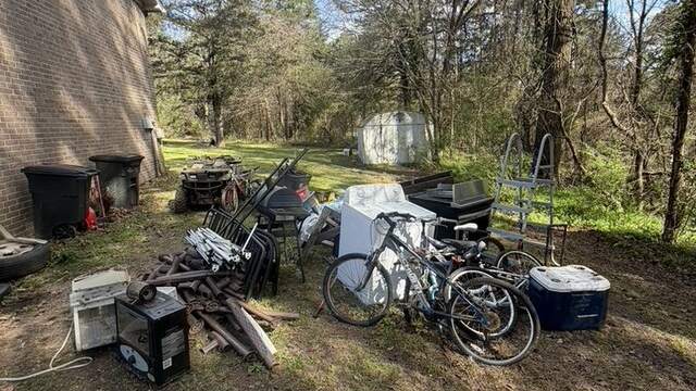 Appliances, bikes, and household junk staged for pickup